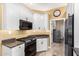Updated kitchen features stainless steel appliances and white cabinetry at 19550 N Grayhawk Dr # 1044, Scottsdale, AZ 85255
