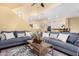 Spacious living room with a large blue sectional sofa and access to the kitchen at 19550 N Grayhawk Dr # 1044, Scottsdale, AZ 85255