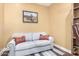 Cozy room showcasing a comfortable couch with decorative pillows and a framed picture of an airplane at 19550 N Grayhawk Dr # 1044, Scottsdale, AZ 85255