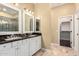 This bathroom has double sinks, vanity with granite countertops, and a walk-in shower at 19550 N Grayhawk Dr # 1044, Scottsdale, AZ 85255