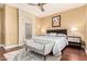 The primary bedroom offers an ensuite bathroom, ceiling fan, shuttered windows and an art piece on the wall at 19550 N Grayhawk Dr # 1044, Scottsdale, AZ 85255
