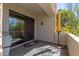 Charming patio with stone flooring, a yellow umbrella, and a peaceful view of the surrounding nature at 19550 N Grayhawk Dr # 1044, Scottsdale, AZ 85255