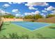 Community tennis court with lights and a viewing bench surrounded by a decorative privacy wall at 19550 N Grayhawk Dr # 1044, Scottsdale, AZ 85255
