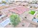 An aerial view showing the house with a red roof, landscaping, and fenced backyard at 25437 W Mahoney Ave, Buckeye, AZ 85326