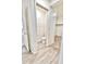 Bathroom with wood-look floors featuring a separate toilet room for added privacy and a closet with shelving at 25437 W Mahoney Ave, Buckeye, AZ 85326