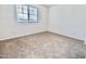 Bedroom featuring carpet, white walls, and a window offering natural light at 25437 W Mahoney Ave, Buckeye, AZ 85326