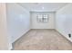 Bright bedroom with plush carpet, white walls, and a window offering natural light at 25437 W Mahoney Ave, Buckeye, AZ 85326