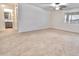 A spacious carpeted bedroom with neutral walls and natural light at 25437 W Mahoney Ave, Buckeye, AZ 85326