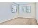 Bright bedroom with plush carpet, white walls, and two windows offering natural light at 25437 W Mahoney Ave, Buckeye, AZ 85326