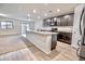 Open-concept kitchen with granite countertops, an island, and stainless steel appliances at 25437 W Mahoney Ave, Buckeye, AZ 85326