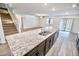 A spacious kitchen island with a sink and a dining room at 25437 W Mahoney Ave, Buckeye, AZ 85326