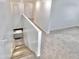 Bright staircase leading to an open area with neutral carpet and views of the kitchen's granite countertops at 25437 W Mahoney Ave, Buckeye, AZ 85326