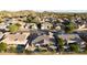 Expansive aerial view of a neighborhood showcasing well-manicured lawns, mature trees, and tile roofs at 25454 N 73Rd Ave, Peoria, AZ 85383