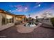 Inviting backyard featuring a pool, covered patio, string lights, and lush landscaping, ideal for entertaining at 25454 N 73Rd Ave, Peoria, AZ 85383