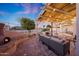 Outdoor living space with a built-in fireplace, comfortable seating, pergola, and view of the sparkling pool at 25454 N 73Rd Ave, Peoria, AZ 85383