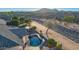 Backyard featuring a private pool, desert landscaping, and an adjacent natural desert wash at 25454 N 73Rd Ave, Peoria, AZ 85383