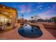 Stunning backyard oasis with a sparkling pool, pergola, outdoor seating area, and lush tropical landscaping at 25454 N 73Rd Ave, Peoria, AZ 85383