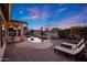 Beautifully landscaped backyard with a pool, pergola, outdoor lounge chairs, and string lights for cozy evenings at 25454 N 73Rd Ave, Peoria, AZ 85383
