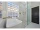 Luxury bathroom with glass block window, a glass shower, and gold fixtures at 25454 N 73Rd Ave, Peoria, AZ 85383
