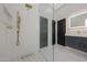 Modern bathroom featuring a glass shower and gray vanity with a light-up mirror at 25454 N 73Rd Ave, Peoria, AZ 85383