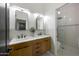 Bright bathroom with double vanity, white subway tiles, and glass-enclosed shower with stylish finishes at 25454 N 73Rd Ave, Peoria, AZ 85383