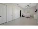 Neutral bedroom featuring sliding closet doors, a ceiling fan, tile flooring, and cozy decor at 25454 N 73Rd Ave, Peoria, AZ 85383