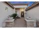 Inviting front entrance with brick pillars, decorative planters, and a cozy bench at 25454 N 73Rd Ave, Peoria, AZ 85383