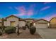 Charming single-story home with a well-manicured desert landscape and a spacious two-car garage at 25454 N 73Rd Ave, Peoria, AZ 85383