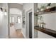 Beautiful hallway with custom floating wood shelves, light grey paint and wood floors with arches at 25454 N 73Rd Ave, Peoria, AZ 85383