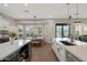 Open kitchen with large islands, stainless steel appliances, dining table and sliding doors to backyard at 25454 N 73Rd Ave, Peoria, AZ 85383
