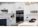 Kitchen features stainless steel appliances, white cabinets and countertops, and modern hardware at 25454 N 73Rd Ave, Peoria, AZ 85383
