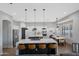 Spacious kitchen with two islands, white cabinetry, stainless appliances and adjacent dining area at 25454 N 73Rd Ave, Peoria, AZ 85383