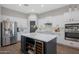 Kitchen boasts stainless steel appliances, white cabinets, a wine cooler and a center island at 25454 N 73Rd Ave, Peoria, AZ 85383