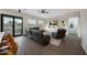 Bright, modern living room with a leather sectional, wood floors, and access to the backyard patio at 25454 N 73Rd Ave, Peoria, AZ 85383