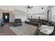Spacious living room features wood floors, a large leather sectional, and ample lighting at 25454 N 73Rd Ave, Peoria, AZ 85383
