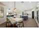 Open floor plan showing the living room, dining area, and kitchen with wood floors and lots of natural light at 25454 N 73Rd Ave, Peoria, AZ 85383
