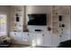 Stylish living room with custom built-in shelving, a TV, and modern decor at 25454 N 73Rd Ave, Peoria, AZ 85383