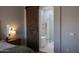 An ensuite bathroom with a large glass shower, soaking tub, and sliding barn door at 25454 N 73Rd Ave, Peoria, AZ 85383