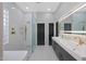 Modern main bathroom with a walk-in shower, soaking tub, double vanity, and sleek fixtures at 25454 N 73Rd Ave, Peoria, AZ 85383