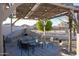 Outdoor patio with a built-in fireplace and seating area covered by a pergola and string lights at 25454 N 73Rd Ave, Peoria, AZ 85383