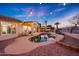Backyard oasis featuring a sparkling pool, covered patio, and scenic landscaping with string lights at 25454 N 73Rd Ave, Peoria, AZ 85383
