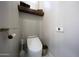 Powder room showcasing modern toilet, floating shelf, and sleek design at 25454 N 73Rd Ave, Peoria, AZ 85383