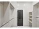 Bright walk-in closet with custom shelving and hanging rods provides ample storage space in this home at 25454 N 73Rd Ave, Peoria, AZ 85383