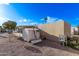 Backyard view of a manufactured home, featuring a storage shed and a gravel landscape at 2650 W Union Hills Dr # 51, Phoenix, AZ 85027