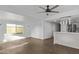 Spacious living area with ceiling fan, white walls, and kitchen access at 2650 W Union Hills Dr # 51, Phoenix, AZ 85027