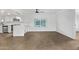 Open-concept living space with wood-look flooring, seamlessly connecting the kitchen and living areas at 2650 W Union Hills Dr # 51, Phoenix, AZ 85027