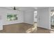 Well-lit living area with wood-look flooring, a ceiling fan and a nearby entryway at 2650 W Union Hills Dr # 51, Phoenix, AZ 85027