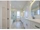 Bathroom featuring a glass shower, dual sink vanity with carrara counters, and lots of light at 28003 N Faded Creek Dr, Florence, AZ 85132