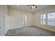 Bedroom with carpet flooring, bright windows, neutral walls, and en suite bathroom at 28003 N Faded Creek Dr, Florence, AZ 85132