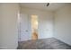 Bright bedroom with a view of an en-suite bathroom and two doors, a clean and minimalist style at 28003 N Faded Creek Dr, Florence, AZ 85132